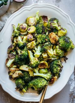 roasted brussels sprouts with broccoli on a white platter