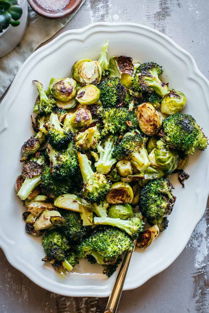 roasted brussels sprouts with broccoli on a white platter