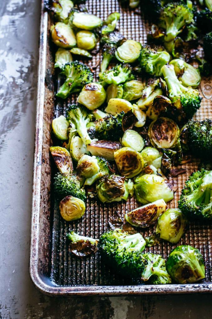 cooked brussels sprouts a nd broccoli on a baking sheet