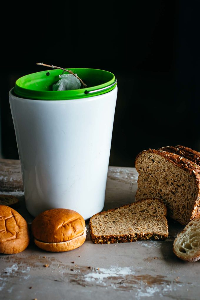 sliced bread next to a countertop compost bin