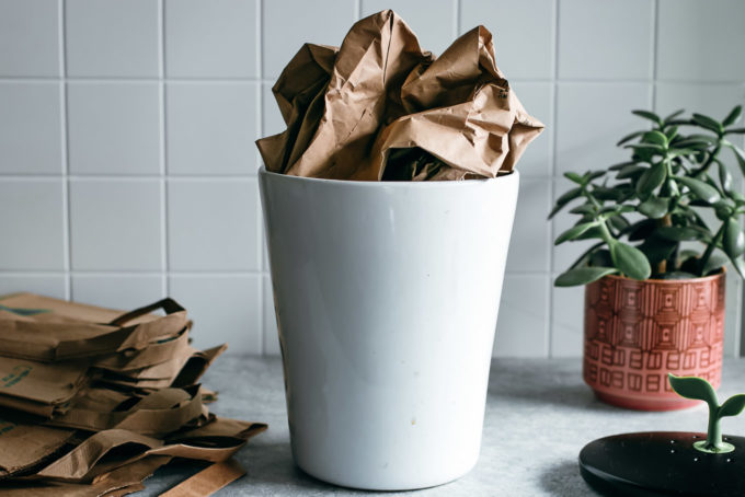 an old paper bag inside of a compost bin on a kitchen countertop