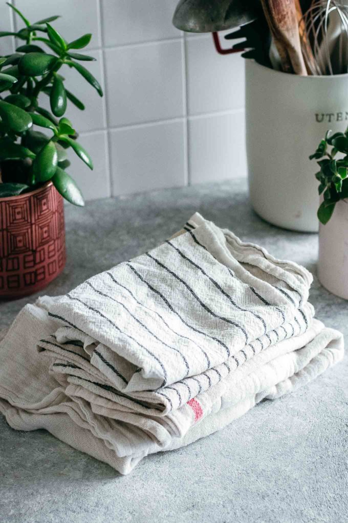 stack of folded cloths on a countertop