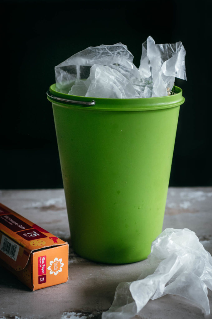 crumpled wax paper in a compost bin