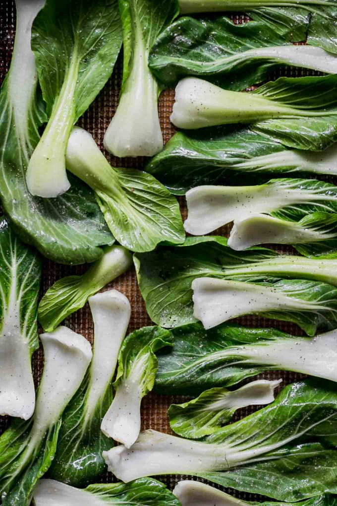 raw bok choy leaves on a baking sheet