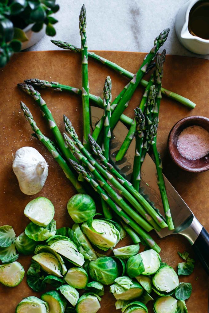 chopped vegetables and spices on a cutting board with a knife