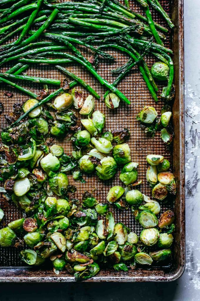 close up of seasoned and roasted vegetables on a baking pan