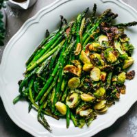 roasted brussels sprouts and asparagus on a white platter
