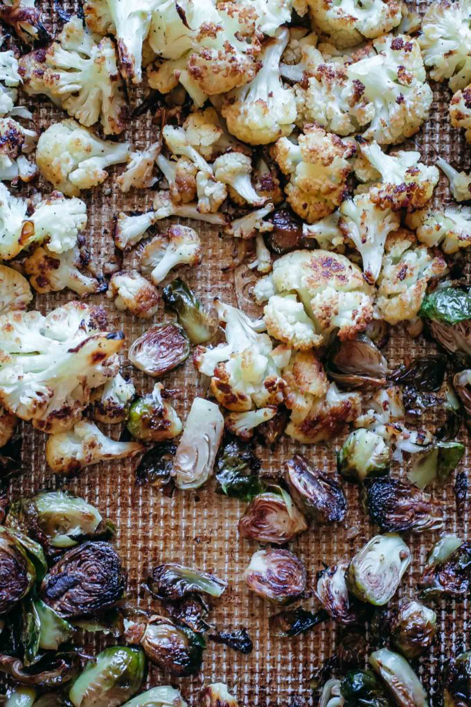 baked cauliflower and brussels sprouts on a baking sheet