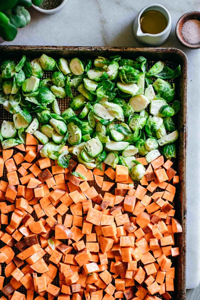 chopped raw vegetables arranged on a baking sheet