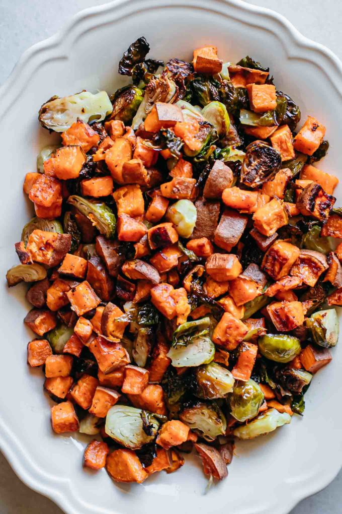 close up of roasted brussels sprouts and sweet potatoes on a plate