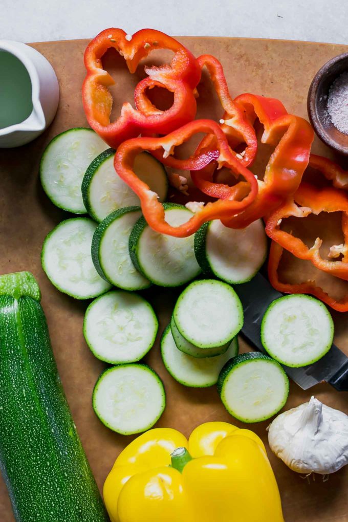 cut zucchini and bell pepper on a cutting board