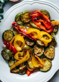 baked bell peppers and zucchini on a white plate