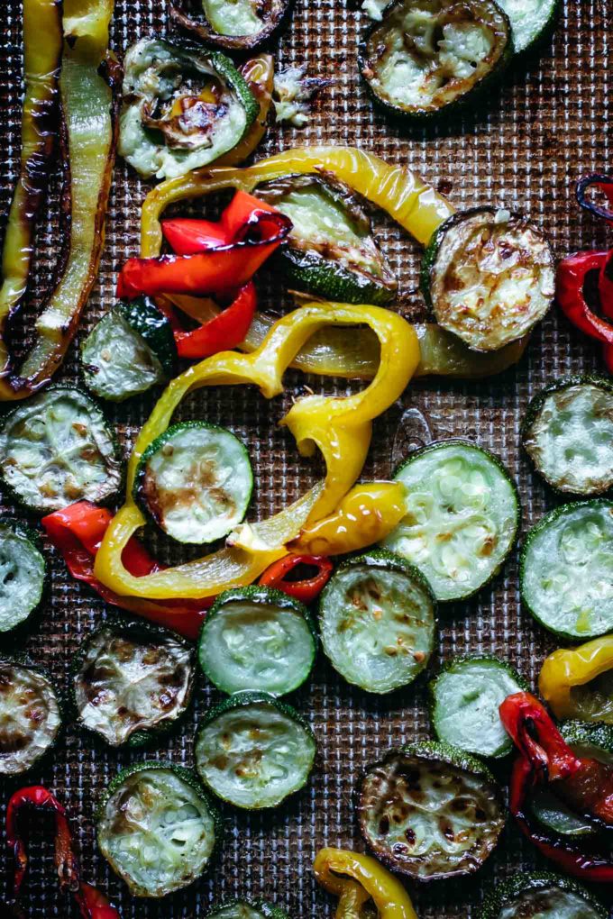baked zucchini and bell peppers on a baking sheet after roasting