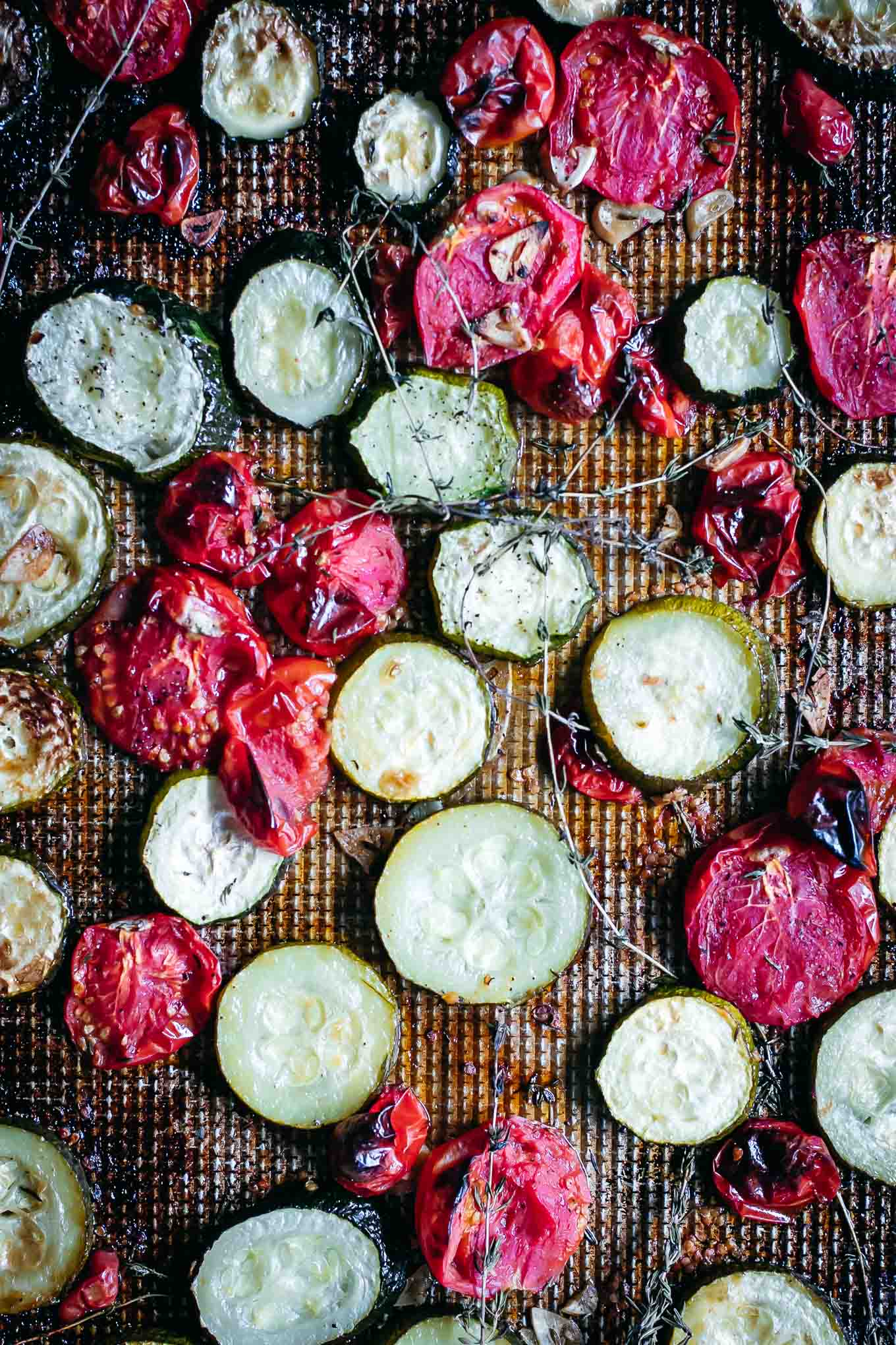 roasted zucchini and tomatoes on a baking sheet