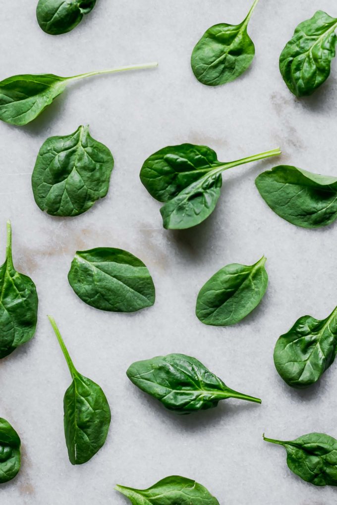 washed and dried spinach leaves on a countertop