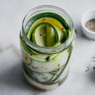 pickled zucchini ribbons on a white table