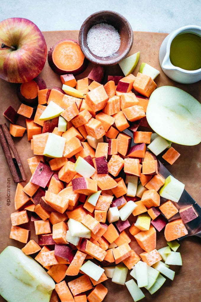 diced sweet potatoes and apples on a wooden cutting board
