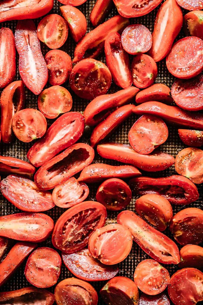 cut tomatoes on a sheet pan