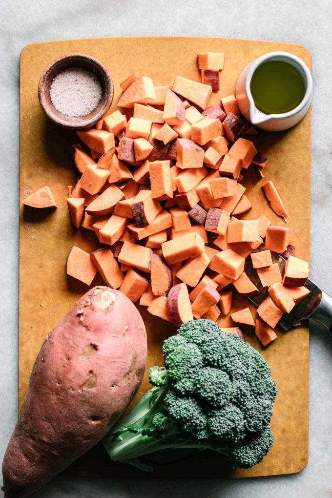 chopped sweet potatoes cubes on a wood cutting board