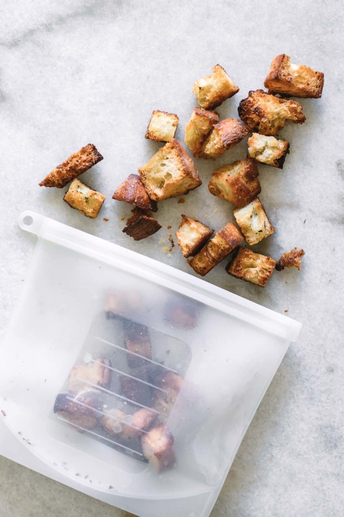 crunchy croutons in a silicone freezer bag on a white table