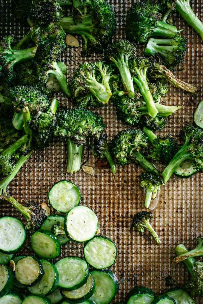 baked broccoli and zucchini on a baking sheet after roasting