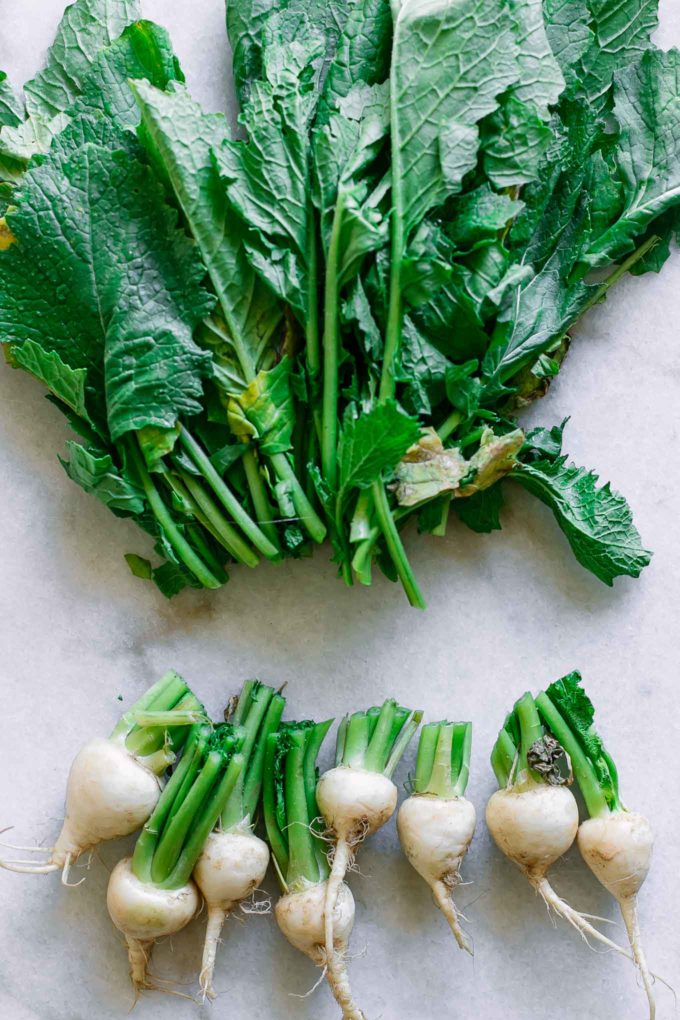 a view of turnip greens that have been cut from the bulbs