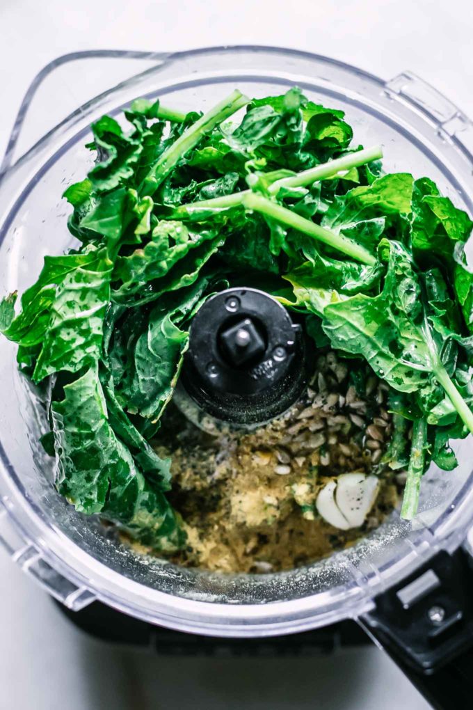 unblended ingredients for turnip greens pesto in a food processor