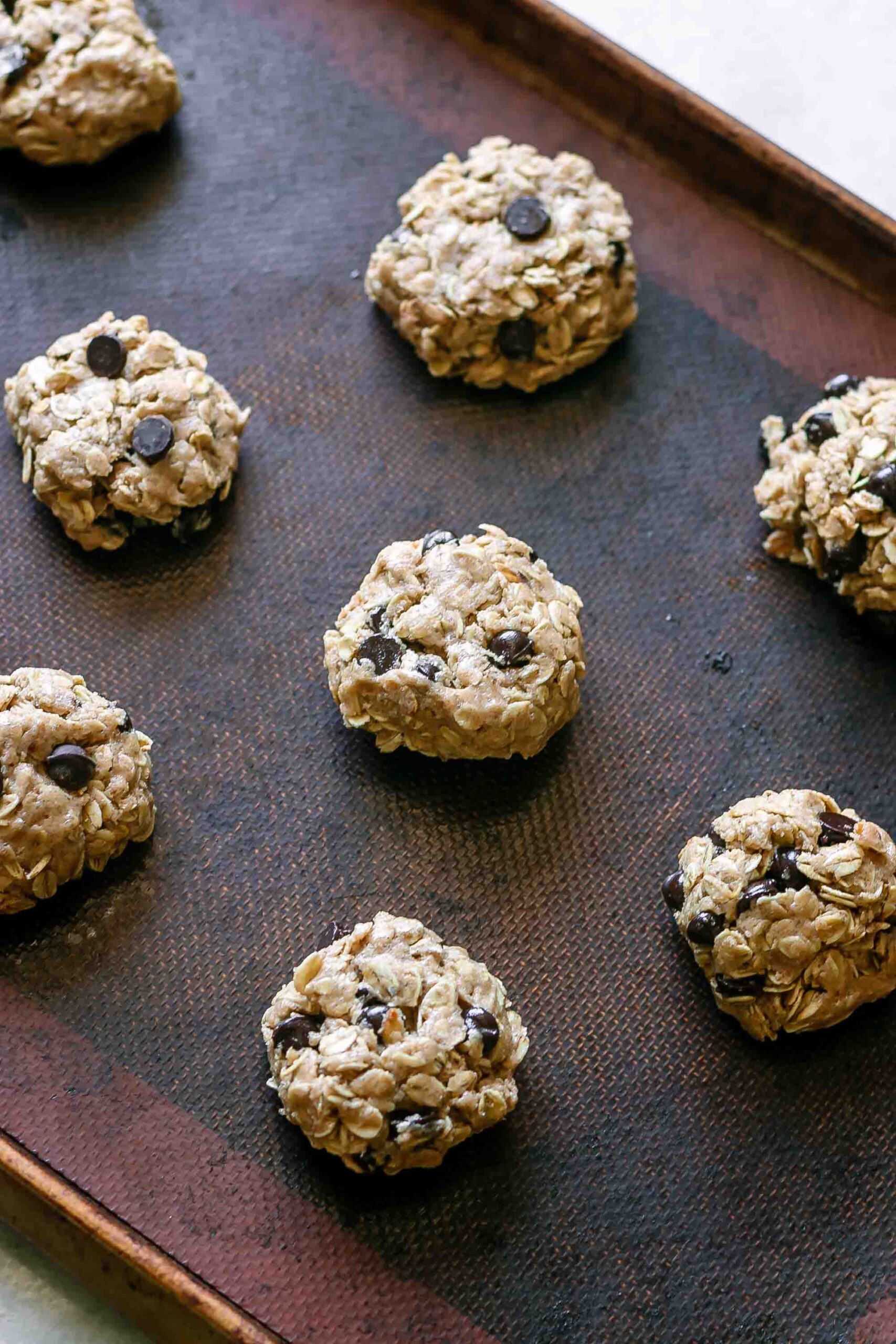 raw cookie dough on a baking sheet before baking