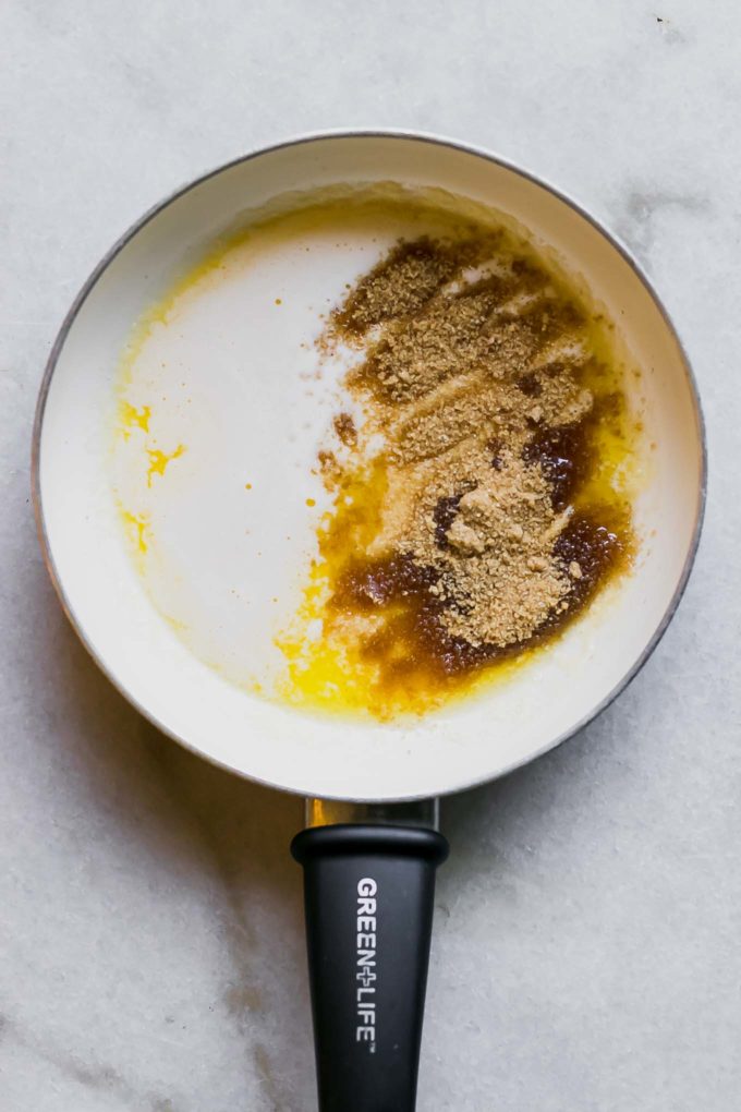 a white sauce pan with melted butter and brown sugar on a white countertop