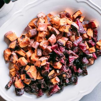 baked beets and sweet potatoes on a white serving plate on a white table