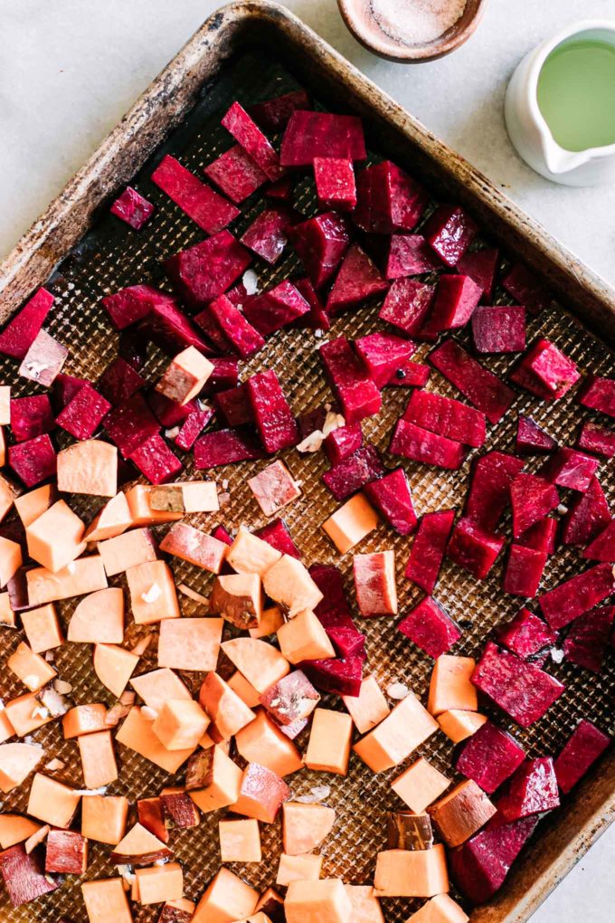 cut beets and sweet potatoes on a baking sheet
