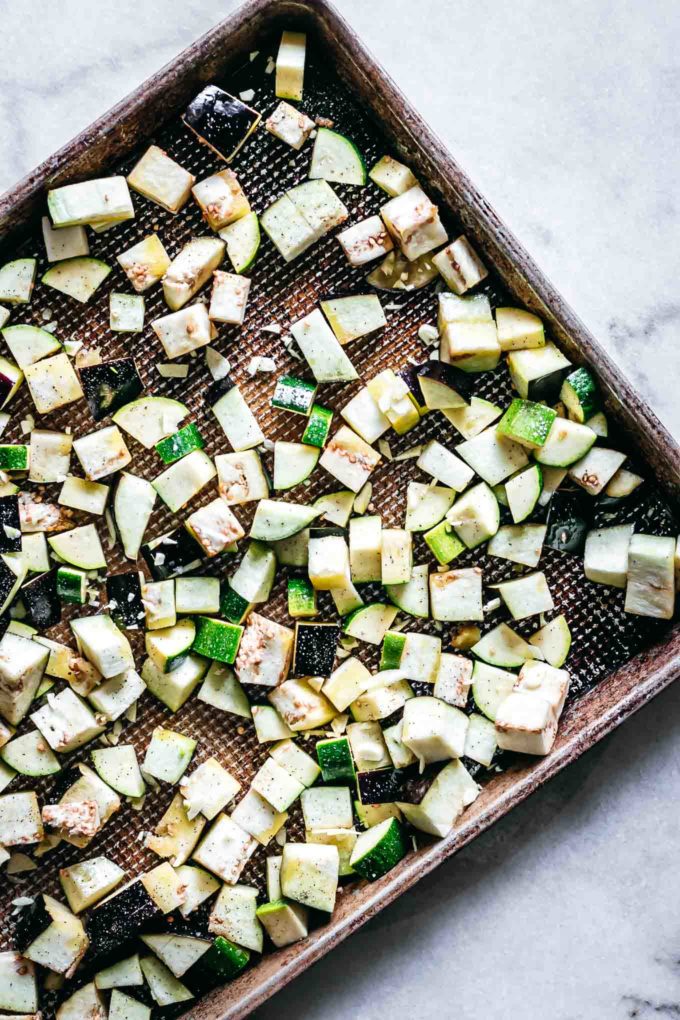 cut zucchini and eggplant cubes on a sheet pan
