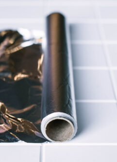 a roll of aluminum foil on a white countertop