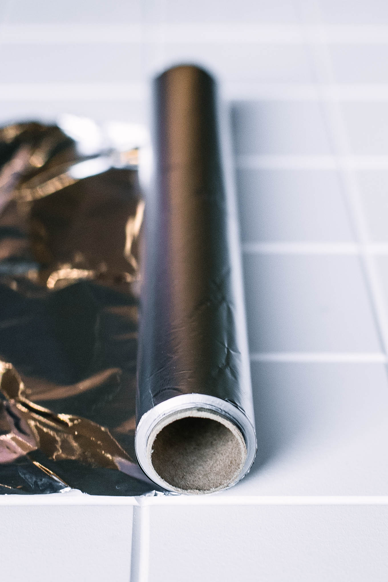 a roll of aluminum foil on a white countertop