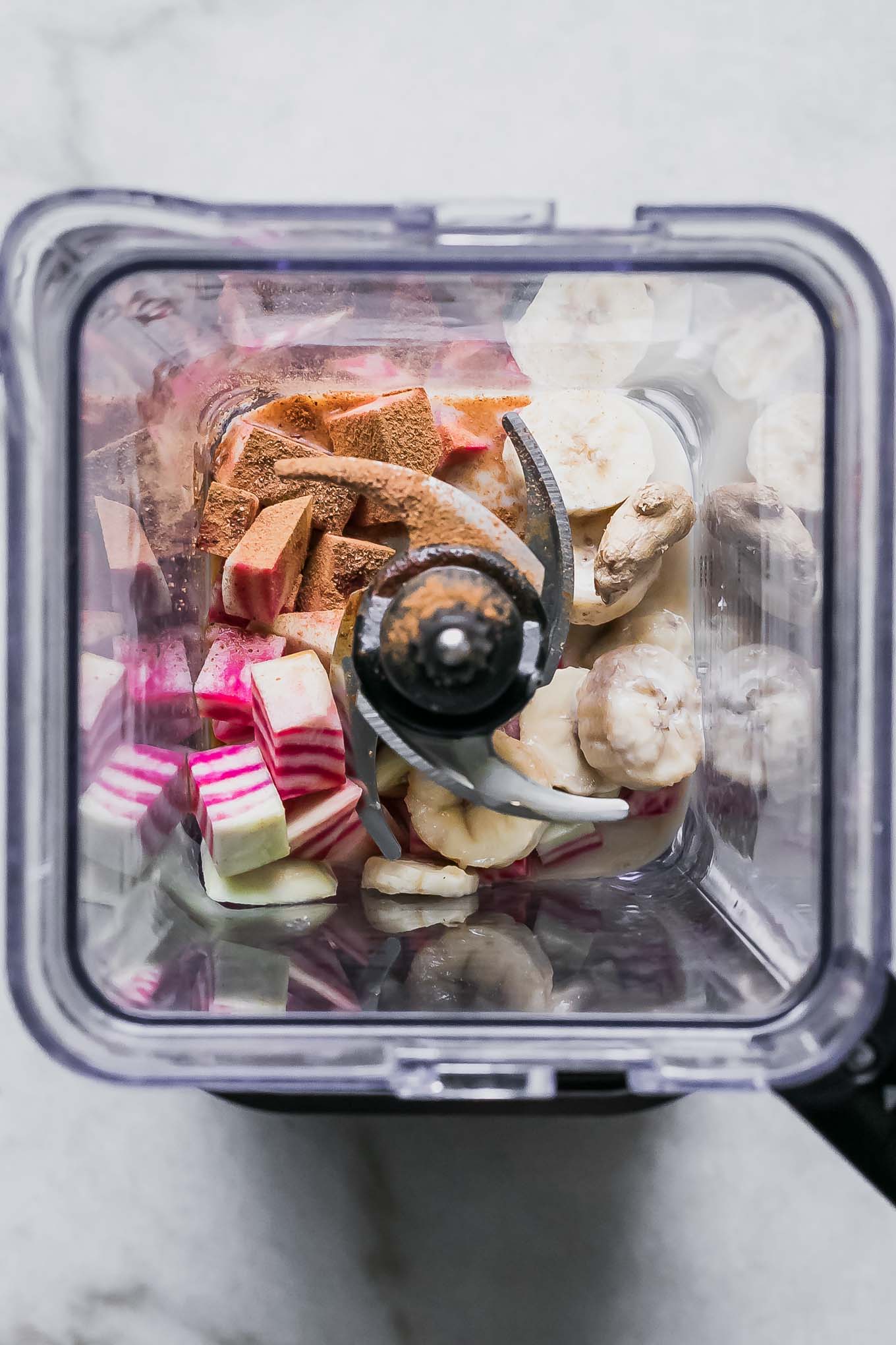 beet tops smoothie ingredients inside a blender