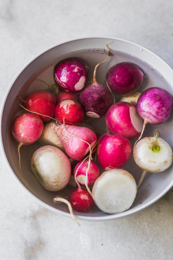 cut radishes in a bowl filled with water