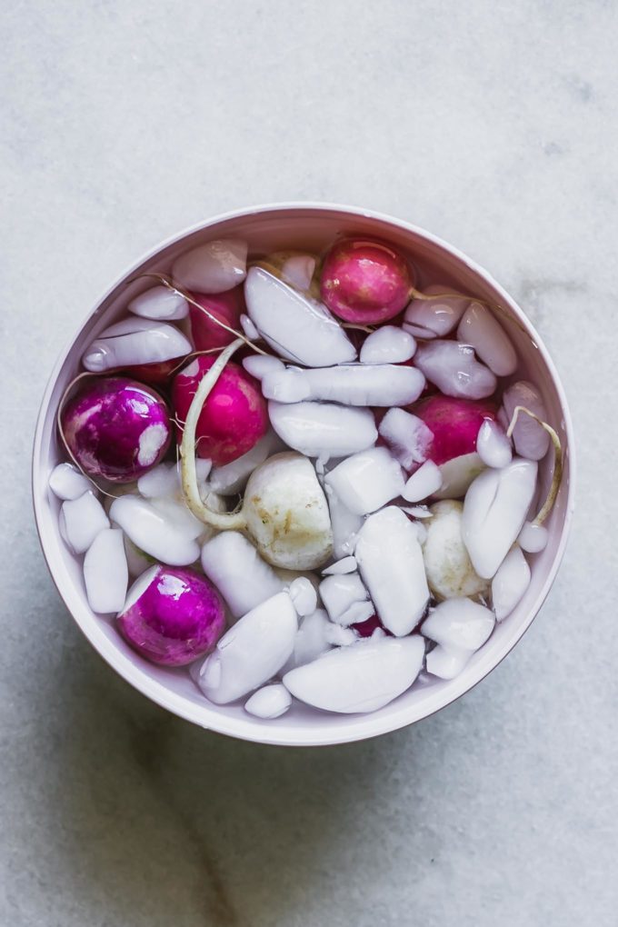 radishes in a bowl of water with ice after blanching