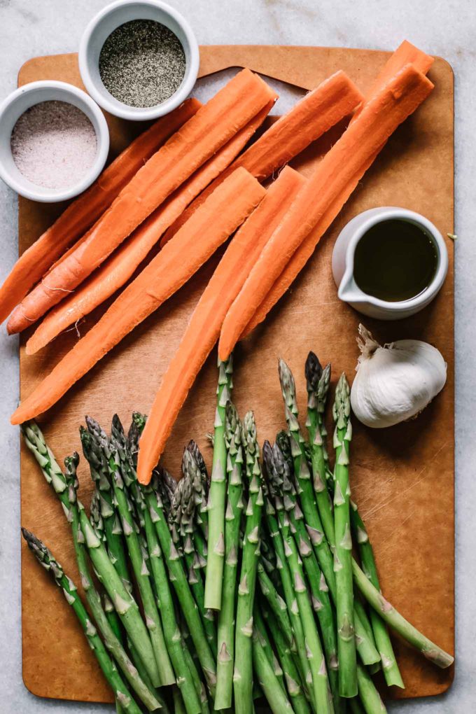 sliced carrots and cut asparagus on a cutting board