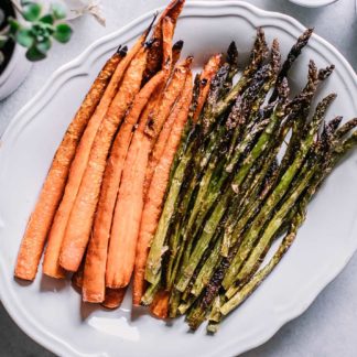 roasted carrot spears and asparagus stalks on a white plate