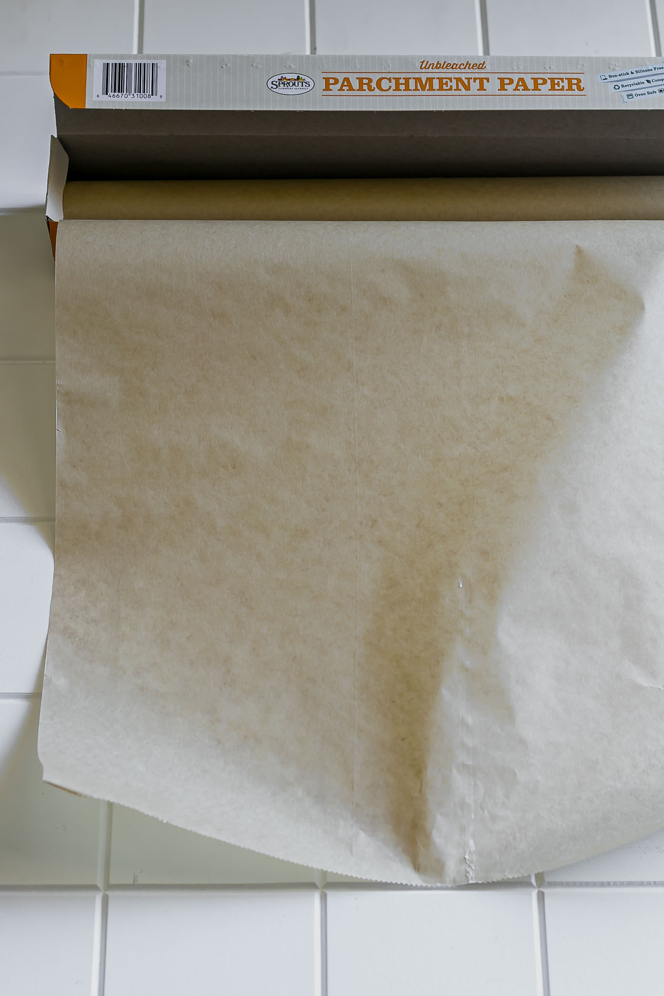 a roll of brown unbleached parchment paper on a white table
