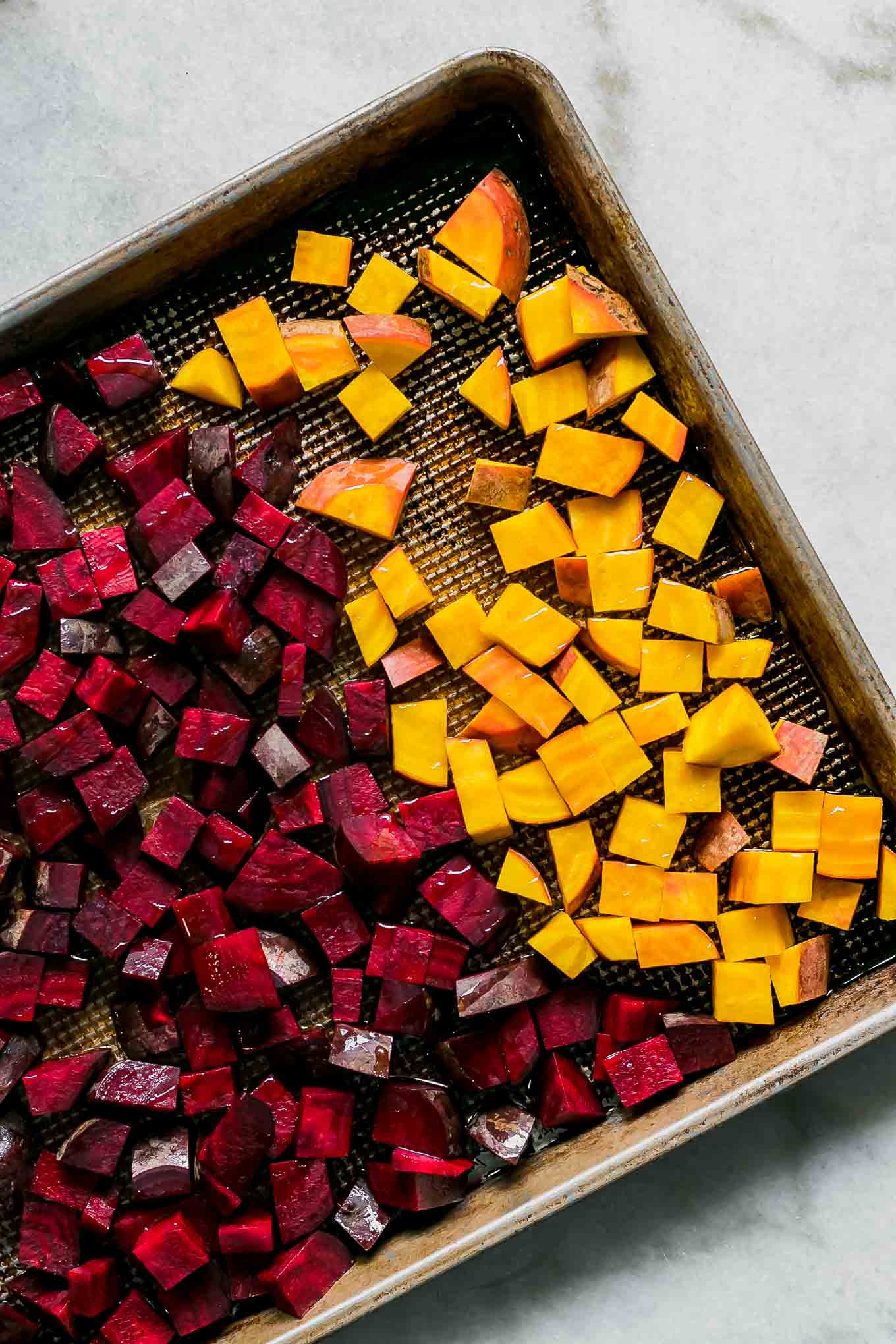 red and golden beets on a roasting pan