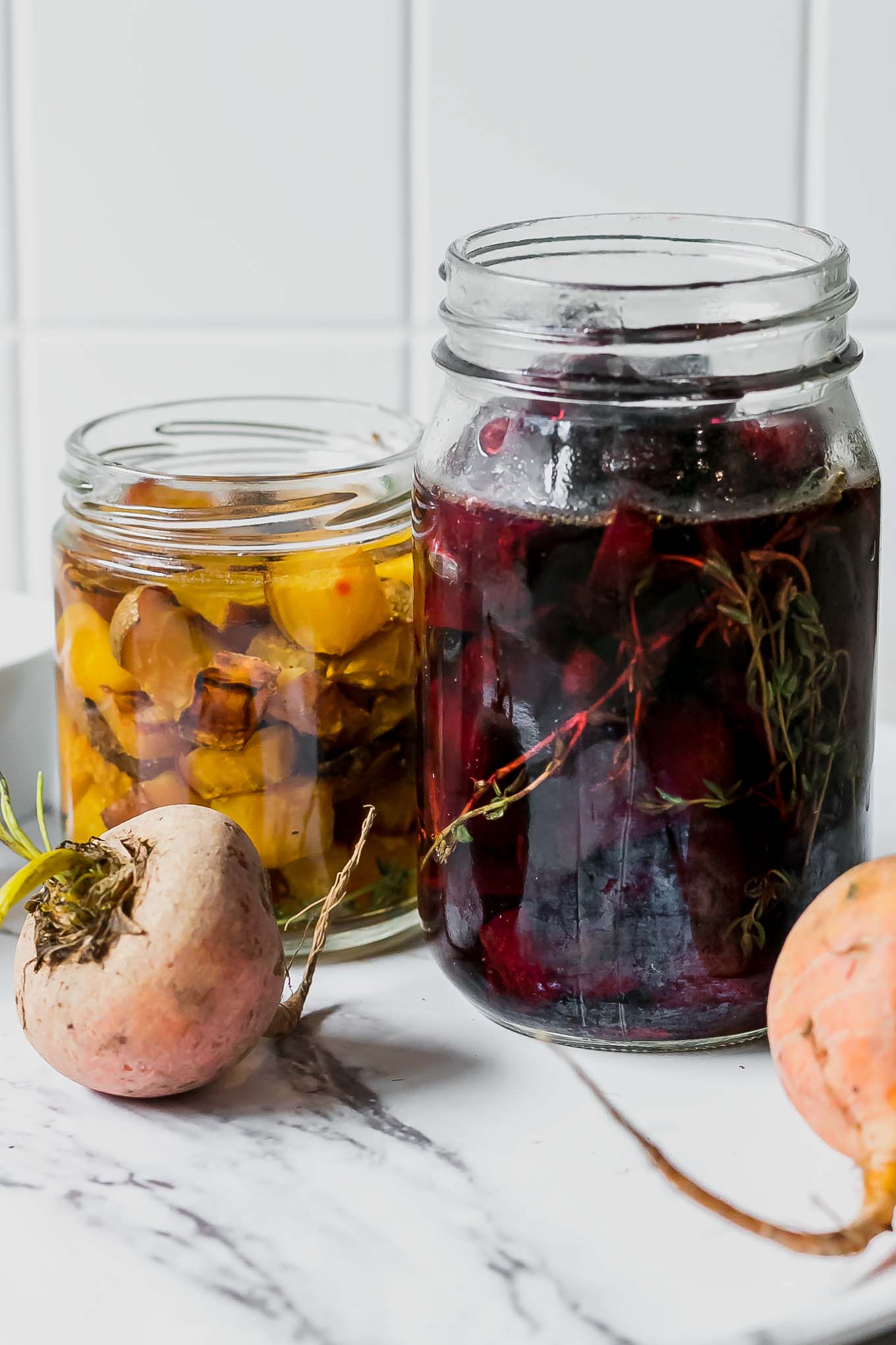 refrigerator pickled beets in glass jars on a white table