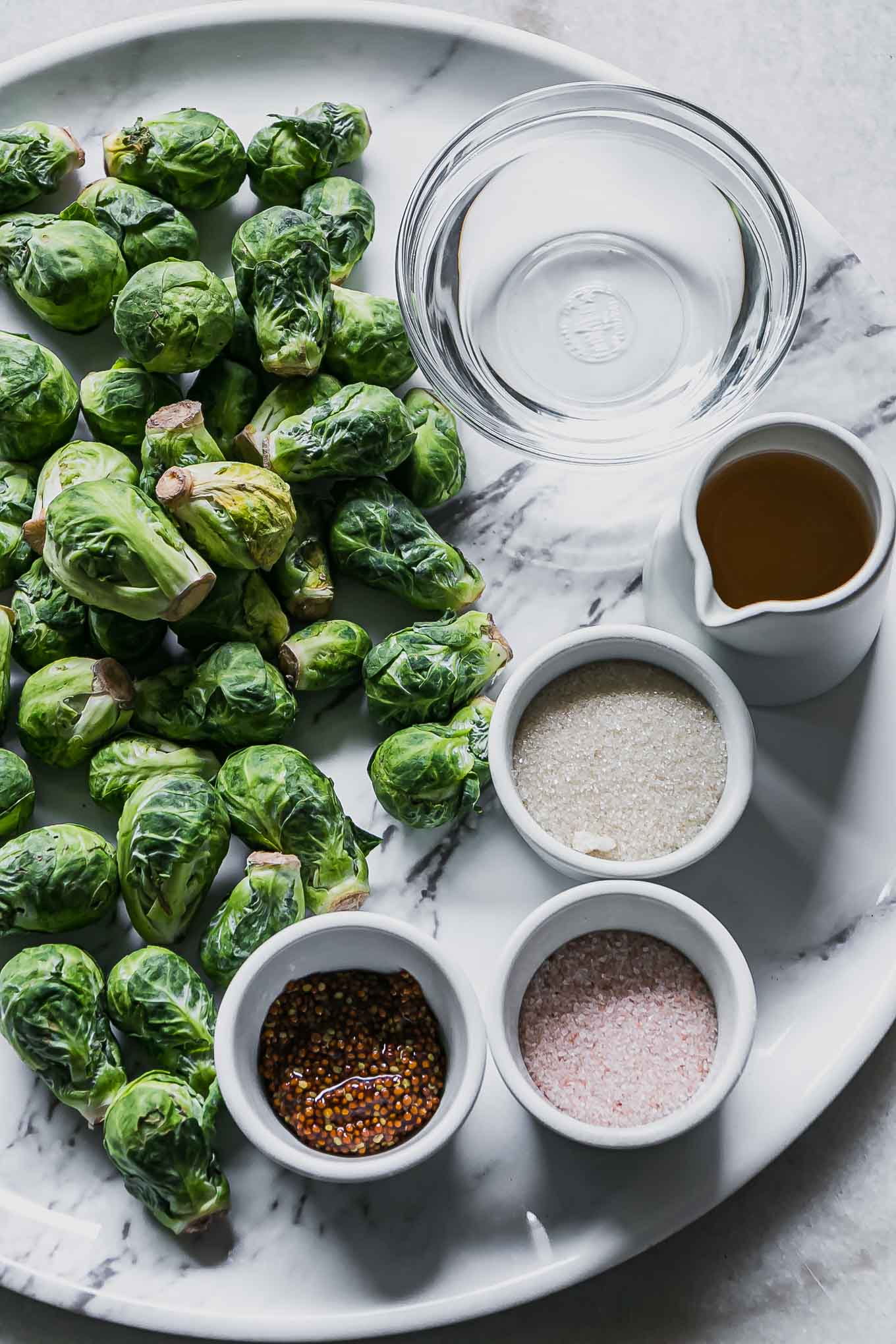 brussels sprouts, water, sugar, vinegar, and salt on a white tray