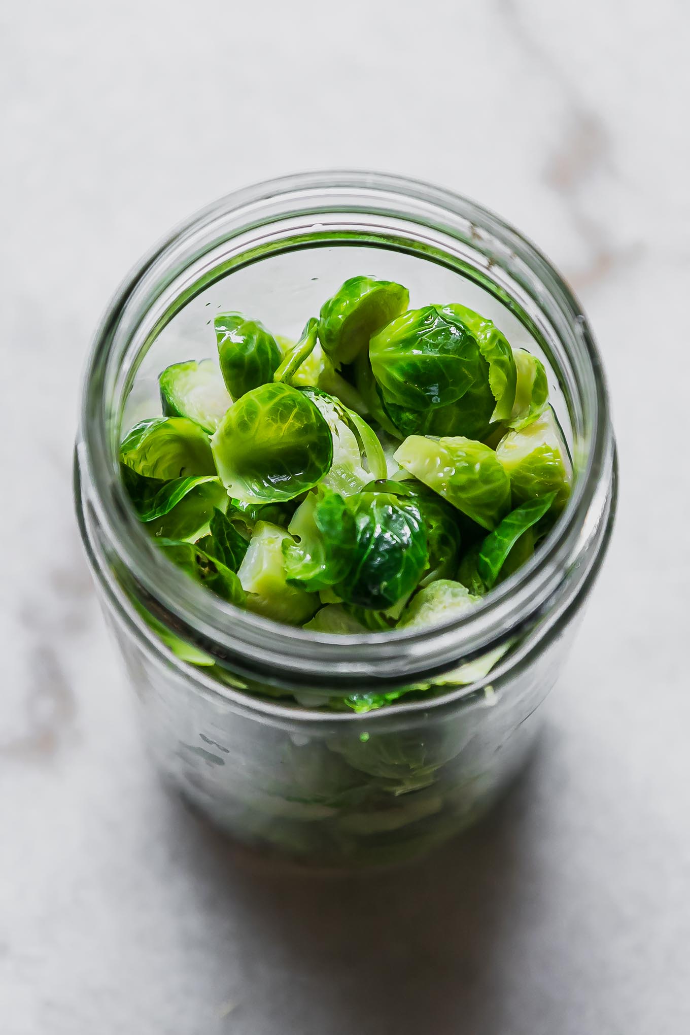 brussels sprouts inside a jar before pickling