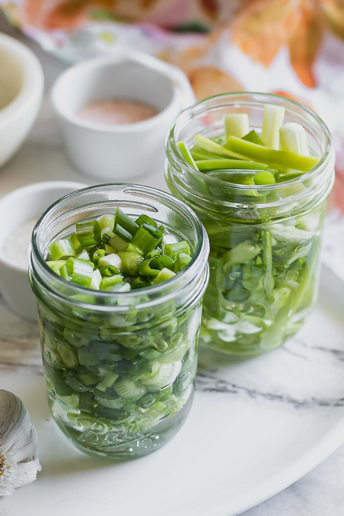 jars of pickled scallions on a table