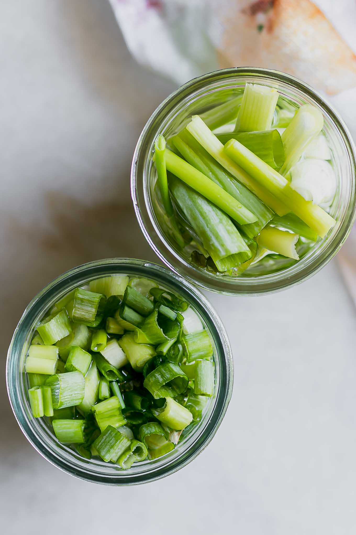 sliced and cut pickled green onions in glass jars