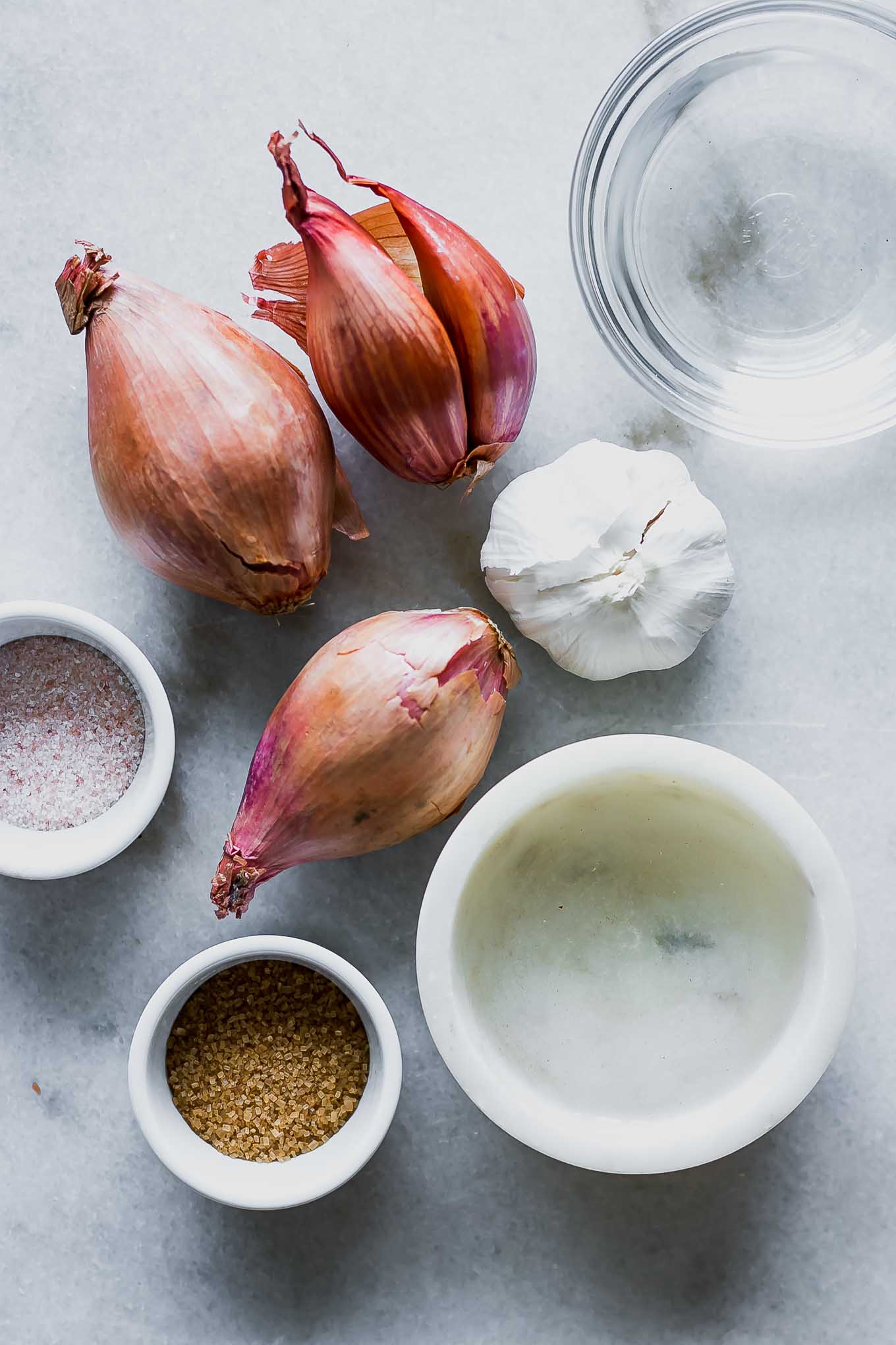 shallots, garlic, and bowls of water, vinegar, salt, and sugar for pickling