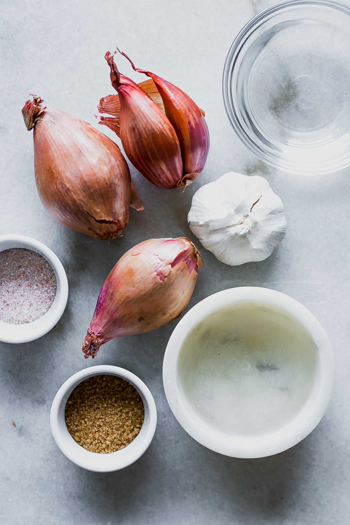 shallots, garlic, and bowls of water, vinegar, salt, and sugar for pickling