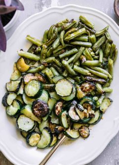 roasted zucchini and green beans side dish on a white plate