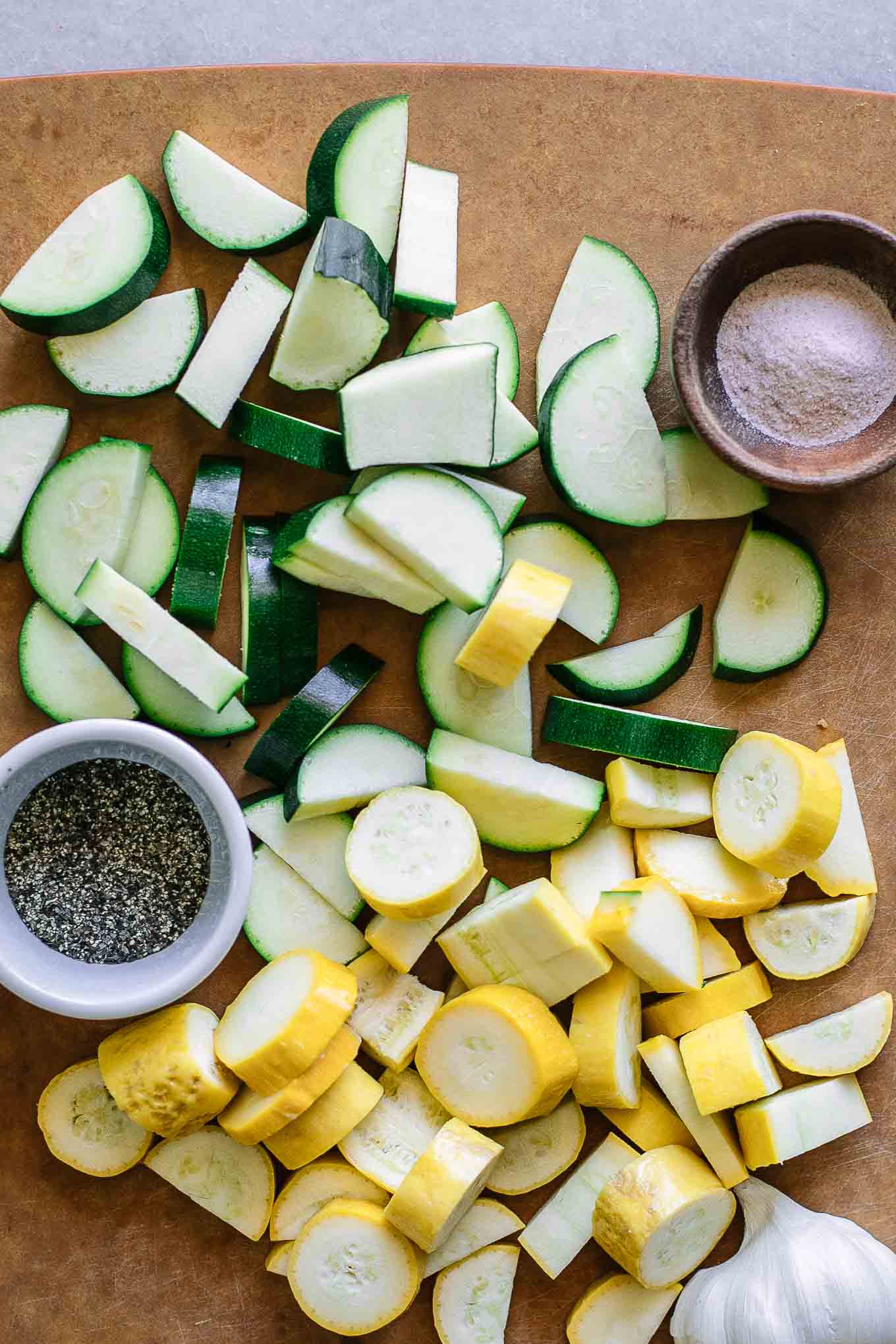 sliced zucchini and summer squash on a cutting board